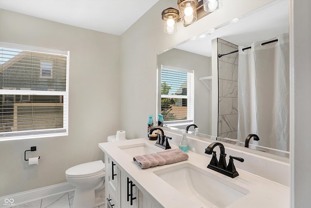 bathroom with marble finish floor, toilet, baseboards, and a sink