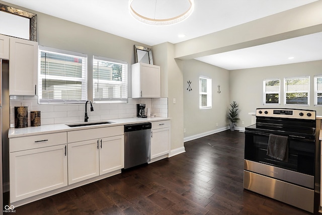 kitchen with stainless steel appliances, dark hardwood / wood-style floors, sink, and white cabinets