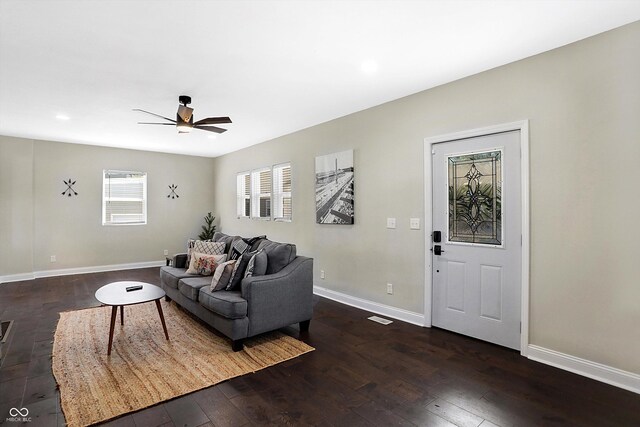 living room with ceiling fan and dark hardwood / wood-style flooring