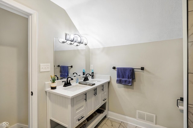 full bathroom featuring a sink, visible vents, lofted ceiling, and marble finish floor