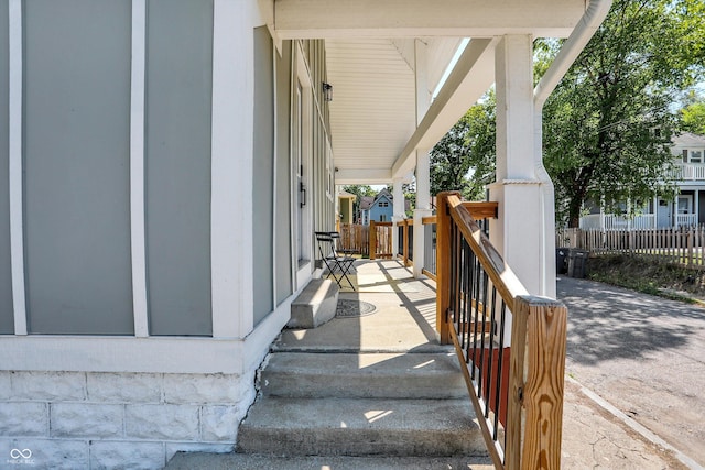 view of patio / terrace with a porch and fence