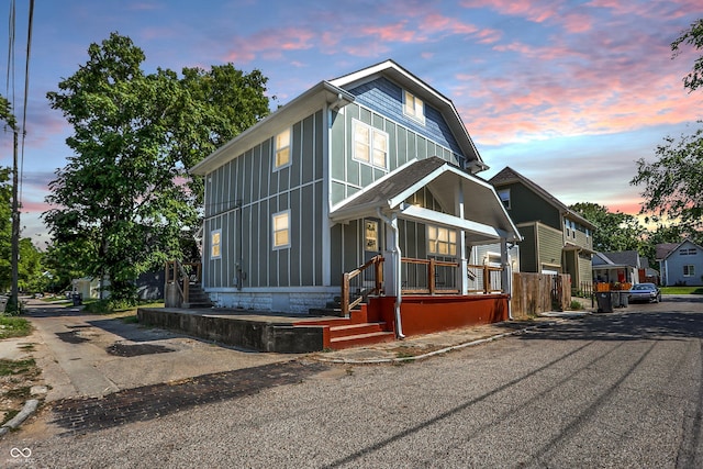 view of front facade featuring aphalt driveway and board and batten siding