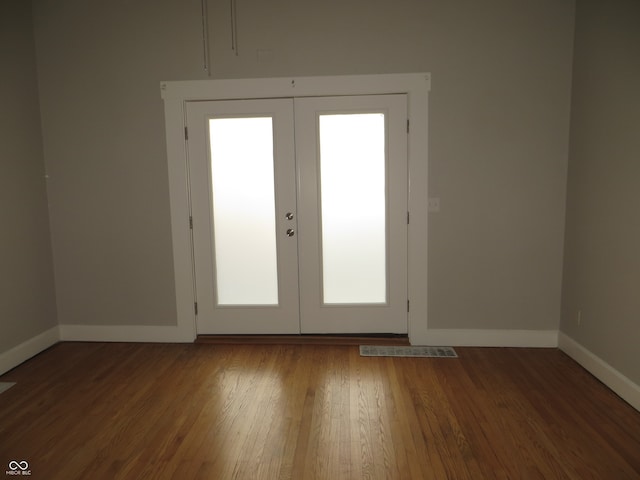 doorway with french doors and wood-type flooring