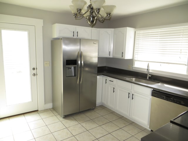 kitchen featuring appliances with stainless steel finishes, sink, a chandelier, white cabinets, and light tile patterned flooring