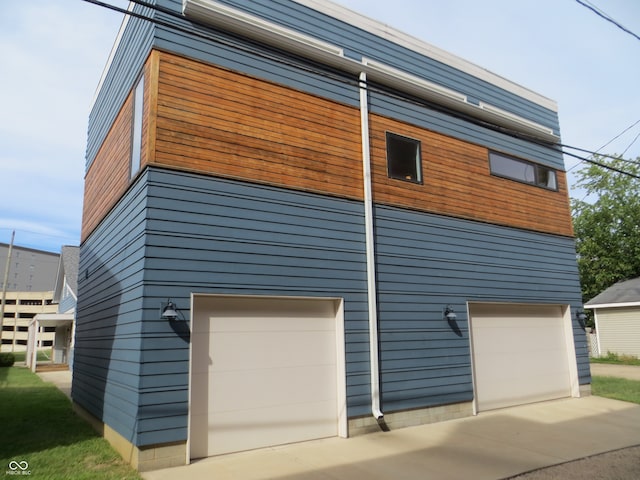 view of side of home featuring a garage