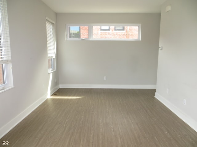 empty room with dark wood-type flooring