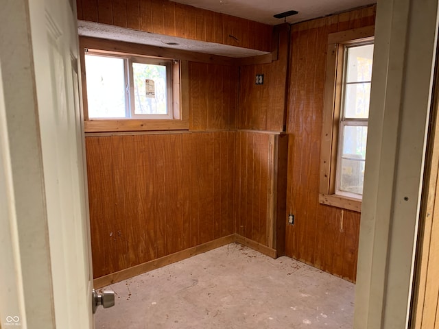 spare room with wood walls