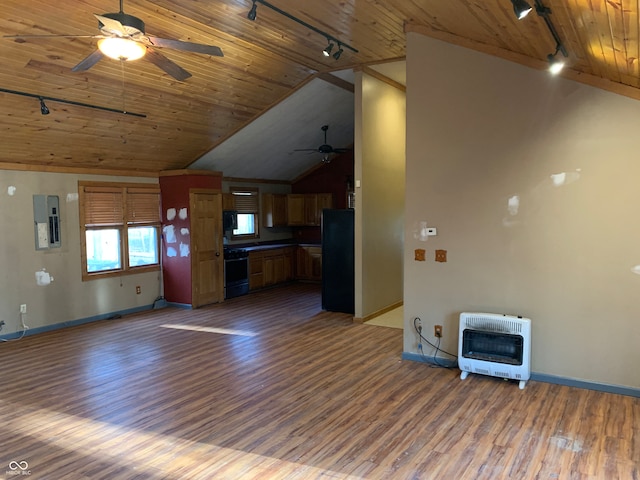 unfurnished living room featuring dark wood-type flooring, heating unit, track lighting, and lofted ceiling