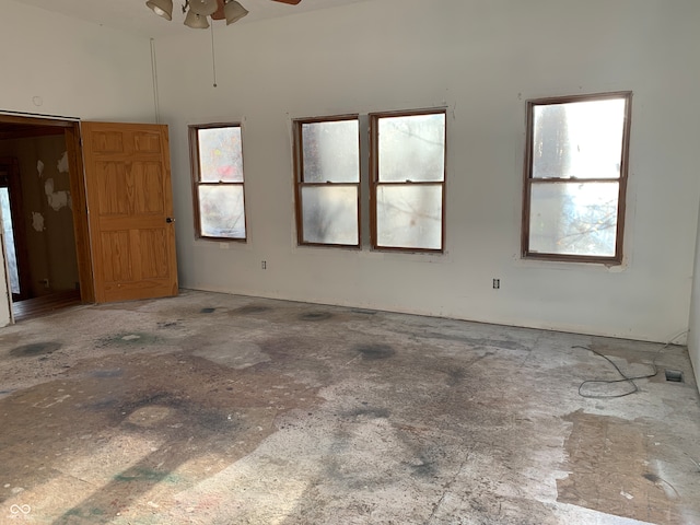 spare room featuring ceiling fan and plenty of natural light