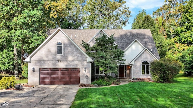 view of front of property with a garage and a front lawn