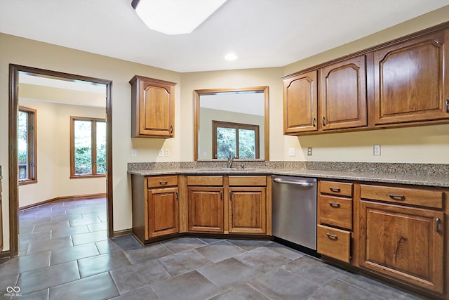 kitchen featuring dishwasher, plenty of natural light, and sink