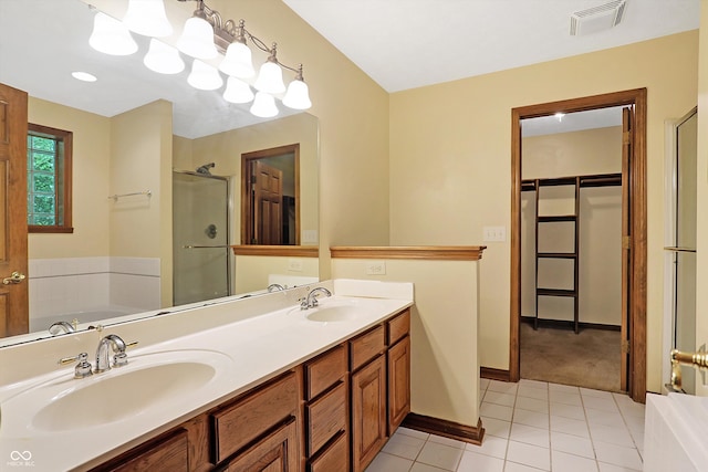 bathroom with tile patterned floors, vanity, and shower with separate bathtub