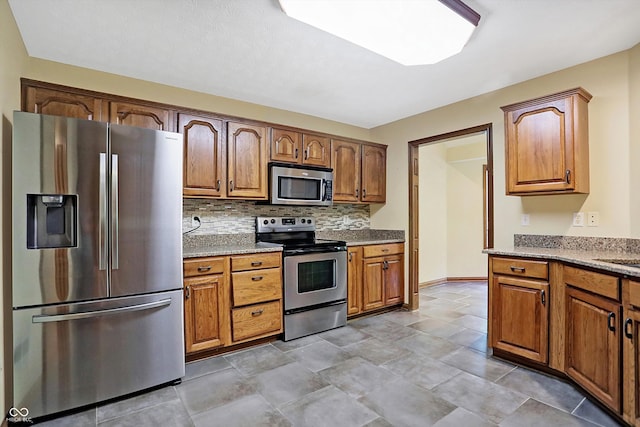 kitchen featuring stainless steel appliances and tasteful backsplash