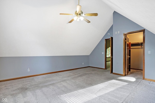 additional living space with ceiling fan, lofted ceiling, and light carpet