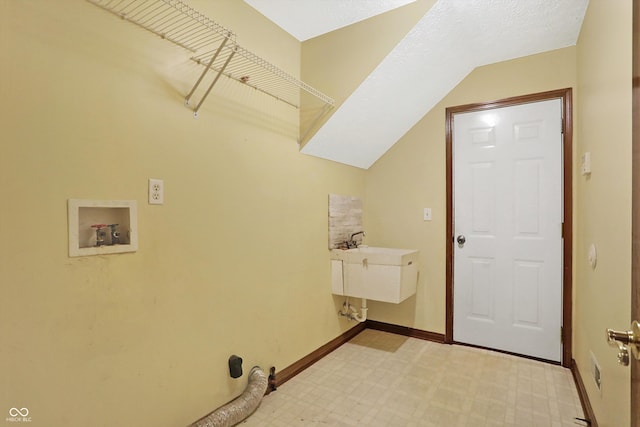 clothes washing area with sink and hookup for a washing machine