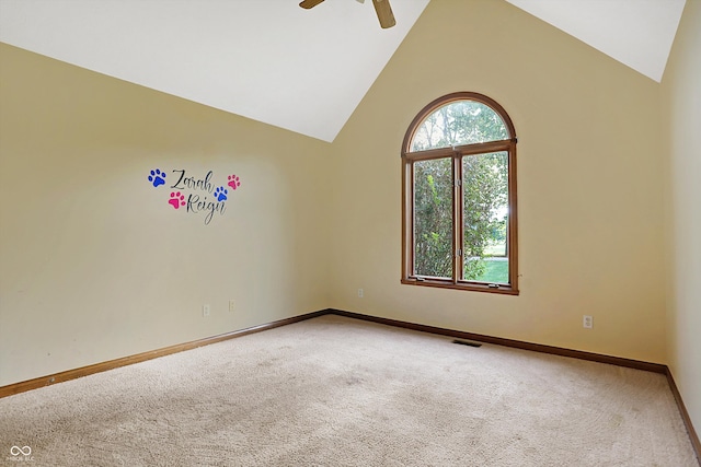 carpeted spare room featuring ceiling fan and lofted ceiling