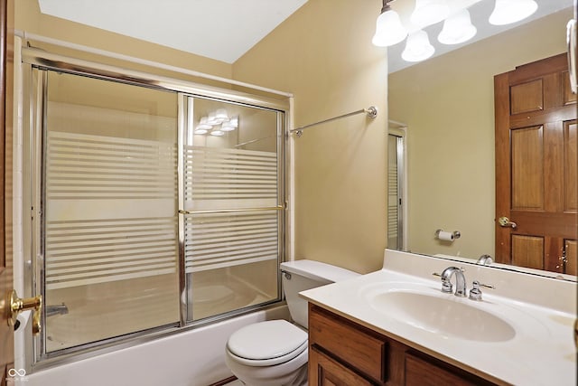 full bathroom with vanity, enclosed tub / shower combo, and toilet