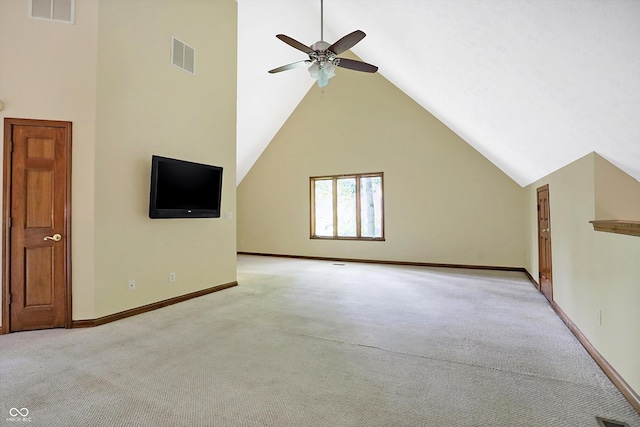 unfurnished living room with ceiling fan, light colored carpet, and high vaulted ceiling