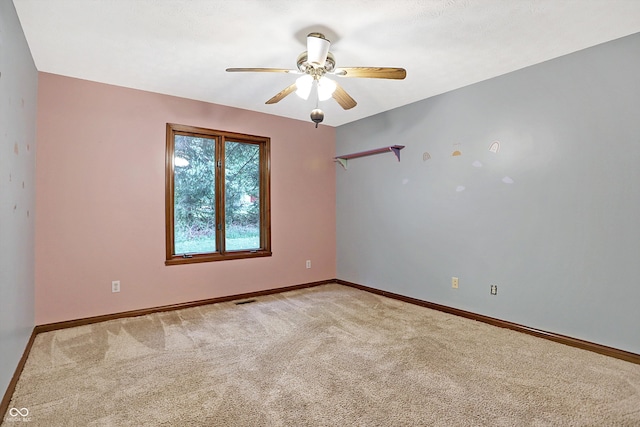 unfurnished room featuring light colored carpet and ceiling fan