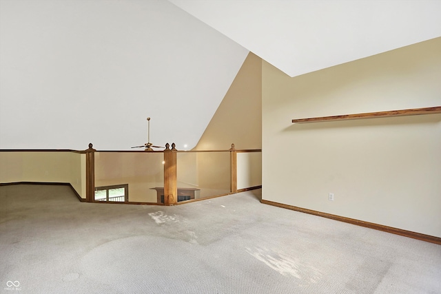 carpeted spare room featuring ceiling fan and lofted ceiling