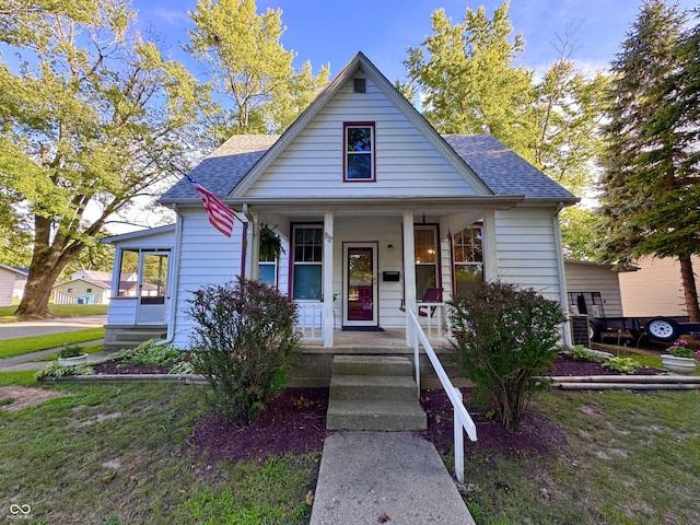 bungalow with a shingled roof and a porch