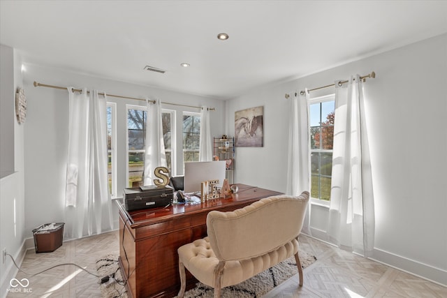 office space with light parquet flooring and a healthy amount of sunlight