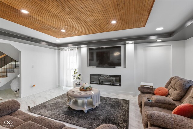 living room with wood ceiling and a tray ceiling