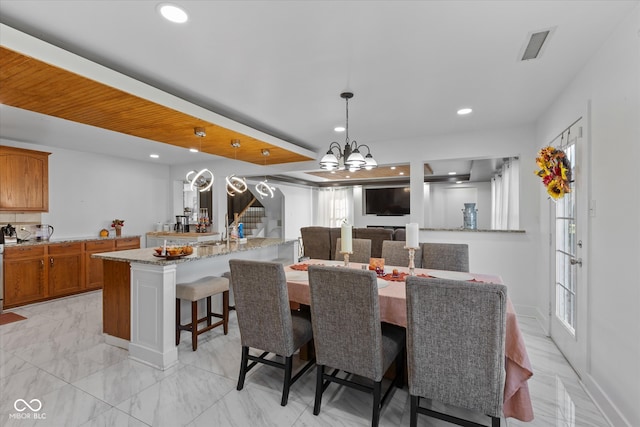 dining area featuring a notable chandelier