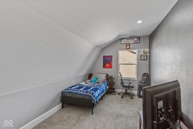 bedroom featuring carpet floors and vaulted ceiling