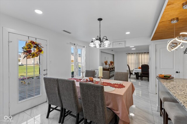 dining room with a wealth of natural light and a notable chandelier