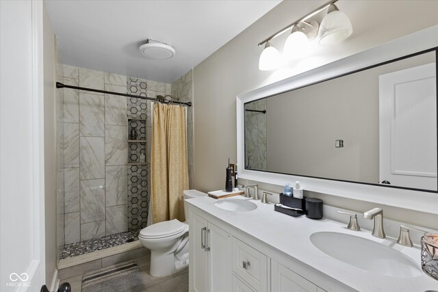 bathroom featuring tile patterned floors, vanity, toilet, and walk in shower