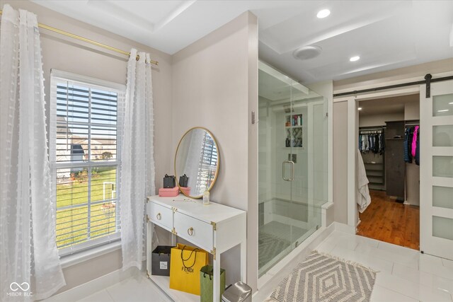 bathroom featuring tile patterned floors and an enclosed shower