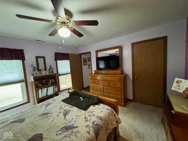 bedroom with light colored carpet and ceiling fan