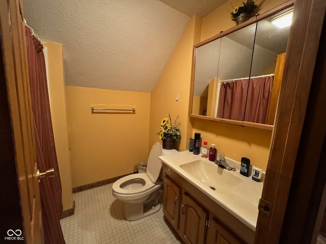 bathroom with toilet, vanity, a textured ceiling, and vaulted ceiling