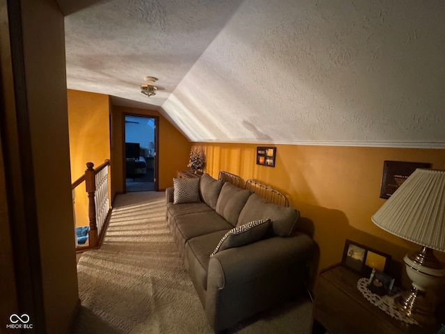 carpeted cinema room with lofted ceiling and a textured ceiling