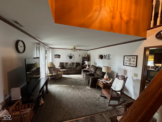 living room with hardwood / wood-style flooring, ceiling fan, and crown molding