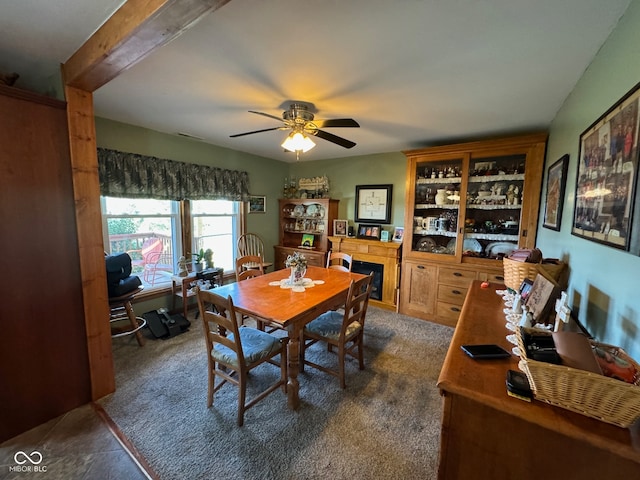 carpeted dining space with ceiling fan