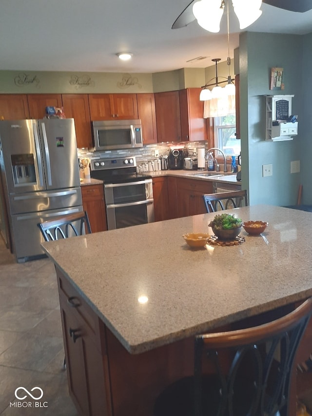 kitchen with a kitchen breakfast bar, stainless steel appliances, and backsplash