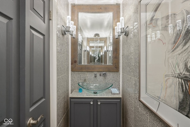 bathroom featuring tile walls and vanity