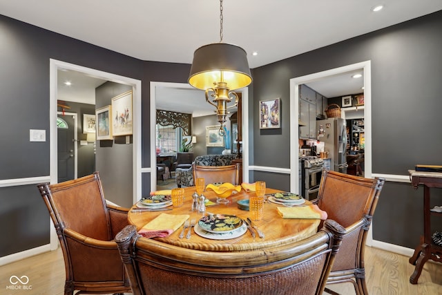 dining space with light hardwood / wood-style flooring