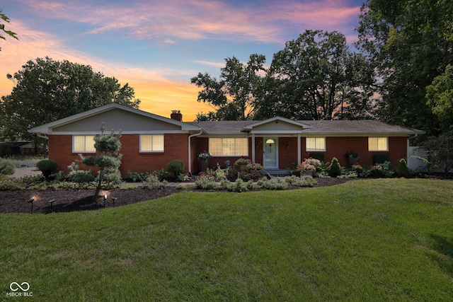 ranch-style house with a lawn