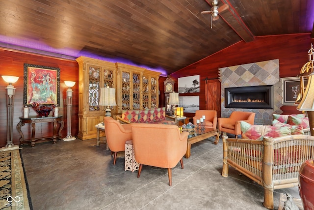 living room with lofted ceiling with beams, wooden walls, wood ceiling, a fireplace, and concrete flooring