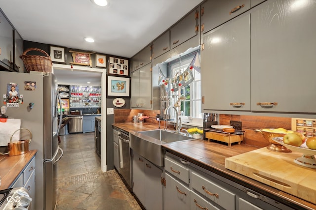 kitchen with gray cabinets, appliances with stainless steel finishes, and sink