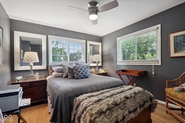 bedroom with ceiling fan and light wood-type flooring