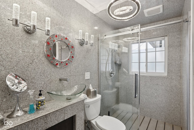 bathroom featuring vanity, tile walls, toilet, and an enclosed shower