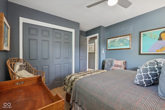 bedroom featuring hardwood / wood-style flooring, ceiling fan, and a closet