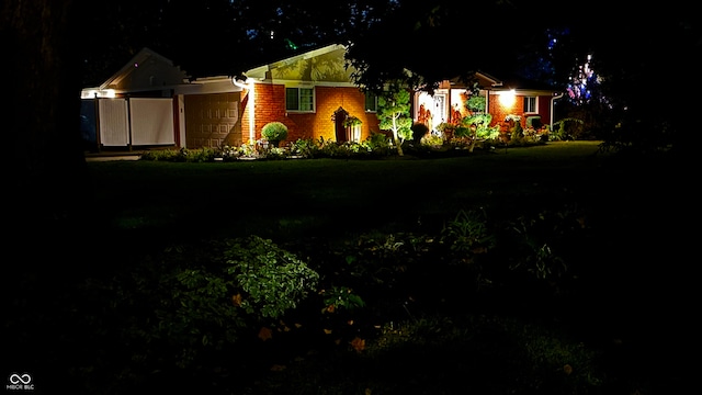 view of front of house featuring a garage and a yard