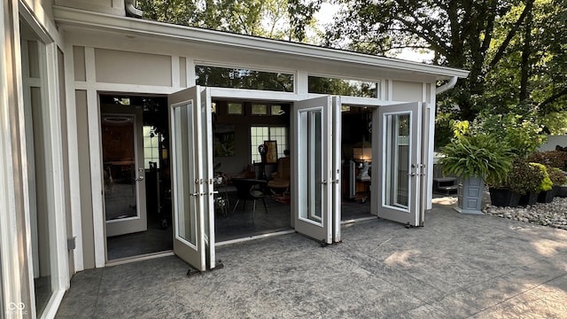 view of exterior entry with a patio and french doors