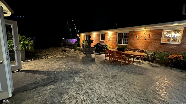 patio at twilight featuring area for grilling