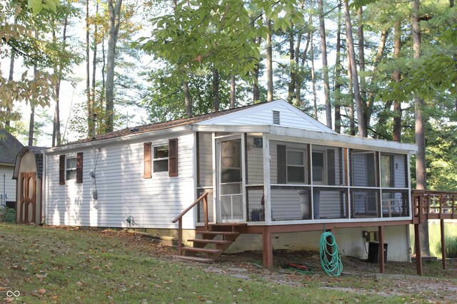 rear view of property with a sunroom